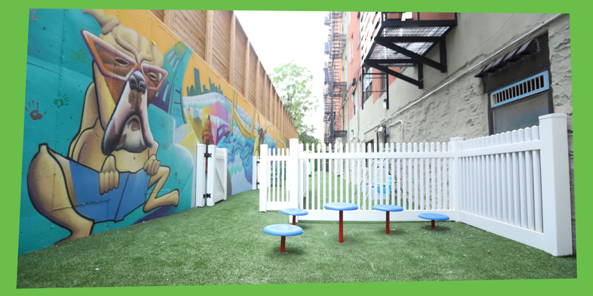 Outside pet play area with a mural