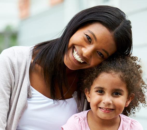 woman leaning head on child. Both smiling